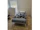 Modest bedroom with white walls, tile flooring, a dresser, and a bed with blanket at 1524 Crawford Dr, Apopka, FL 32703