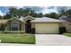 Charming single story home with a well maintained lawn, neutral colors, and a two car garage at 1524 Crawford Dr, Apopka, FL 32703