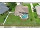Home with a screened-in pool and spacious backyard, next to neighborhood homes and the street at 1546 Royal Cir, Apopka, FL 32703