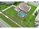 Home highlighting a large screened pool and backyard, near the street and local homes in the neighborhood at 1546 Royal Cir, Apopka, FL 32703