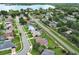 Neighborhood aerial view with water views, showcasing a community of homes with well-kept landscaping and nearby roads at 1546 Royal Cir, Apopka, FL 32703