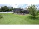 Spacious backyard featuring a screened-in pool area and well-maintained lawn at 1546 Royal Cir, Apopka, FL 32703