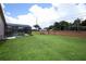 Expansive backyard featuring a screened-in pool and lush green lawn at 1546 Royal Cir, Apopka, FL 32703
