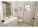 Bright bathroom featuring a white sink, toilet, and access door to the back yard at 1546 Royal Cir, Apopka, FL 32703