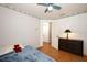 Simple bedroom with light wood floor and a view into the hallway at 1546 Royal Cir, Apopka, FL 32703