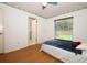 Simple bedroom with light wood floor, natural light and view of lawn at 1546 Royal Cir, Apopka, FL 32703