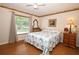 Cozy bedroom features natural light, neutral walls, ceiling fan and wood-look flooring at 1546 Royal Cir, Apopka, FL 32703