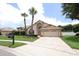 Well-maintained home with a spacious driveway, lush lawn, and mature landscaping at 1546 Royal Cir, Apopka, FL 32703