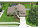 Well-manicured single-Gathering home boasts a lush lawn, mature landscaping, and a screened-in pool for outdoor relaxation at 1546 Royal Cir, Apopka, FL 32703