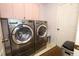 Laundry room featuring modern washer and dryer units and a tiled floor at 1546 Royal Cir, Apopka, FL 32703