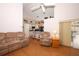 Open living room with wood floors flows into the kitchen, offering a cozy and inviting space at 1546 Royal Cir, Apopka, FL 32703