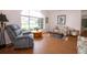 Open living room with large bright window, hardwood floors, and cozy seating at 1546 Royal Cir, Apopka, FL 32703