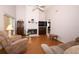 Inviting living room features a cozy fireplace, wood-look flooring and high ceiling at 1546 Royal Cir, Apopka, FL 32703