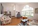 Bright living room with large arched windows, wood floor, and floral sofas at 1546 Royal Cir, Apopka, FL 32703