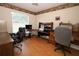 Well-lit home office with wood flooring, a large window, and a built in work station desk at 1546 Royal Cir, Apopka, FL 32703