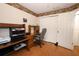 Cozy home office with wood flooring, closet, and built in desk workspace at 1546 Royal Cir, Apopka, FL 32703