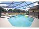Sparkling pool in a screened enclosure, complimented by lounge chairs and a spa at 1546 Royal Cir, Apopka, FL 32703
