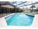Beautiful screened-in pool with a spa, surrounded by a deck and lush landscaping at 1546 Royal Cir, Apopka, FL 32703