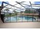 Screened-in pool with safety fence, floats, and surrounding patio at 1546 Royal Cir, Apopka, FL 32703
