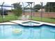 Inviting pool with a built-in spa and colorful inflatable ring floating in the water at 1546 Royal Cir, Apopka, FL 32703
