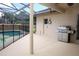 Covered patio with BBQ grill, door, and an amazing view of the pool at 1546 Royal Cir, Apopka, FL 32703