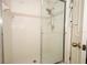 Bathroom shower featuring sliding glass door, dual shower heads, and clean white tile at 1546 Royal Cir, Apopka, FL 32703