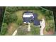 Aerial view showcases a large lot with lush landscaping, pool, and mature trees at 1795 Markham Glen Cir, Longwood, FL 32779