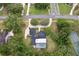 An aerial view shows a large lot, mature landscaping, and a private tennis court at 1795 Markham Glen Cir, Longwood, FL 32779