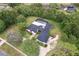 Aerial shot of home showcasing lush landscaping, mature trees, and winding driveway at 1795 Markham Glen Cir, Longwood, FL 32779