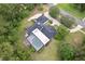 An aerial view reveals a spacious home with a screened pool and mature trees at 1795 Markham Glen Cir, Longwood, FL 32779