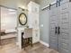 Charming bathroom vanity area with custom cabinetry, stylish fixtures, and a barn door for added character at 1795 Markham Glen Cir, Longwood, FL 32779