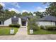 Stylish exterior features a black and white color scheme and a well-manicured front lawn at 1795 Markham Glen Cir, Longwood, FL 32779