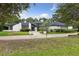 Charming white-brick home with modern black trim and well-manicured landscaping creates an inviting curb appeal at 1795 Markham Glen Cir, Longwood, FL 32779