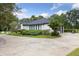 Charming single-story home featuring a basketball court, mature trees, and beautiful landscaping at 1795 Markham Glen Cir, Longwood, FL 32779