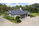 A well-maintained exterior with a two-car garage and mature landscaping at 1795 Markham Glen Cir, Longwood, FL 32779