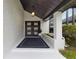 Inviting entryway featuring a dark-colored double door, modern lighting, and a cozy welcome mat at 1795 Markham Glen Cir, Longwood, FL 32779