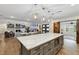 Open kitchen with a large island, modern appliances, and a view into the living and dining areas at 1795 Markham Glen Cir, Longwood, FL 32779