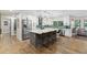 Spacious kitchen features a large island with seating, stainless steel appliances, and modern white cabinetry at 1795 Markham Glen Cir, Longwood, FL 32779