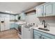 Spacious laundry room with blue cabinets, white countertops, stainless steel appliances, and wood floors at 1795 Markham Glen Cir, Longwood, FL 32779