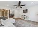 Cozy living room features a ceiling fan, stylish rug, and a view into the kitchen for easy entertaining at 1795 Markham Glen Cir, Longwood, FL 32779