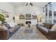 Spacious living room with high ceilings, brick fireplace, and large windows, perfect for gatherings at 1795 Markham Glen Cir, Longwood, FL 32779