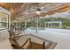 A covered outdoor pool area with stylish seating, ceiling fans, and integrated lighting for evening swims at 1795 Markham Glen Cir, Longwood, FL 32779