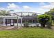 A screened-in pool with a pergola is surrounded by lush landscaping in this backyard oasis at 1795 Markham Glen Cir, Longwood, FL 32779