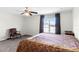 Comfortable bedroom with neutral carpet, bright window, chair and warm bedding at 1907 Lakeview Way, Kissimmee, FL 34759