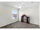 Spacious bedroom with neutral carpeting, bright window, and classic décor at 1907 Lakeview Way, Kissimmee, FL 34759