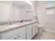 A bright bathroom features a double sink with granite countertops and tile flooring at 1997 Standing Rock Cir, Oakland, FL 34787