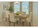 Inviting dining area with a wooden table, tufted chairs, and natural light from large windows at 1997 Standing Rock Cir, Oakland, FL 34787