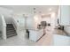 Open kitchen with a granite island, stainless steel appliances, white cabinets and tile flooring at 1997 Standing Rock Cir, Oakland, FL 34787
