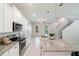 Spacious kitchen featuring stainless steel appliances, granite counters and an open staircase at 1997 Standing Rock Cir, Oakland, FL 34787