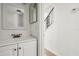 Hall bathroom with bronze fixtures, white vanity, and doorway to the staircase at 2250 S Palmetto Ave # I-11, Daytona Beach, FL 32119